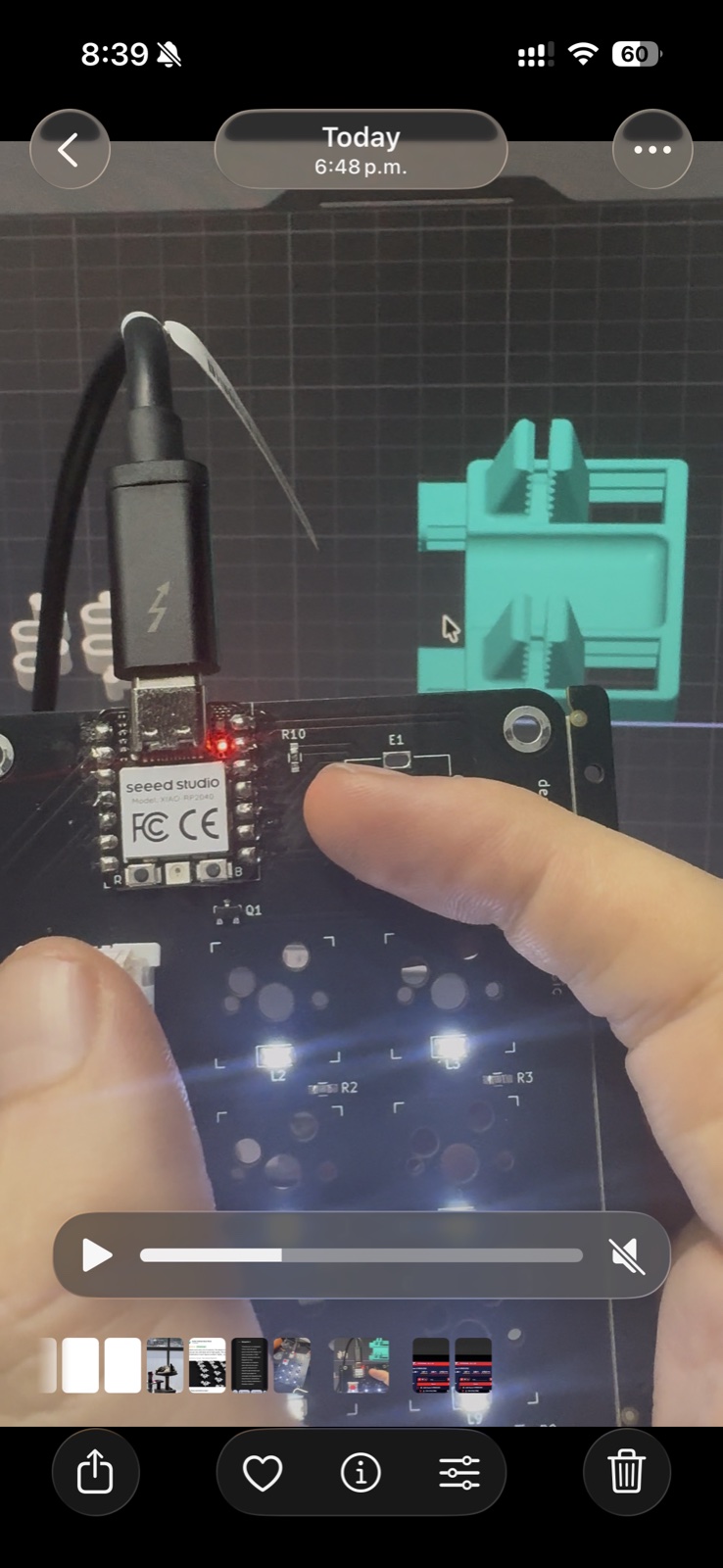 The macropad PCB plugged in via USB-C, finger pointing at a key, backlight LEDs visibly on under each switch socket.